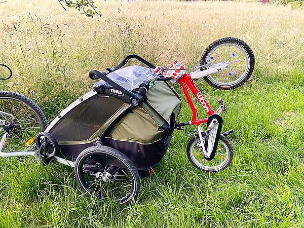 Woom am Kinderanhänger mit clips befestigt.
