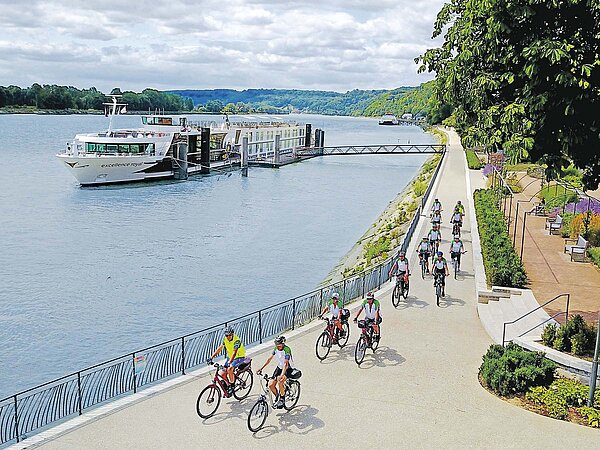 Eine Velogruppe fahrt entlang dem Fluss Seine