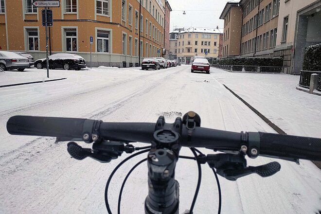 Winter Bike To Work Day 2023. Ein Fahrrad fährt auf einer Schnee bedeckten Strasse.