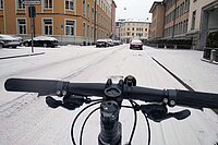Winter Bike To Work Day 2023. Ein Fahrrad fährt auf einer Schnee bedeckten Strasse.