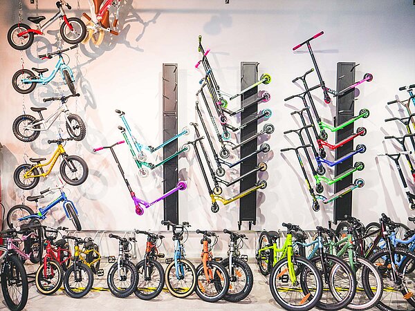 Kindervelos und Trottis stehen in einem Laden.