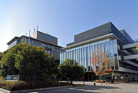 Quartalszahlen der Fahrradbranche. Firmengebäude, vor dem Bäume stehen. 