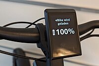 Was kostet das Aufladen des E-Bike Akkus. Ein Display zeigt an, dass ein Akku voll geladen ist.
