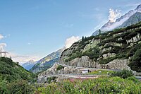 Alpenbrevet 2024 ausverkauft. Passstrasse mit vielen Radfahrern und Bergpanorama im Hintergrund.