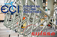 Logos von ECI und Velosuisse vor E-Bike-Rahmen.