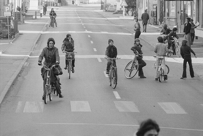 Auch in den 1970ern gab es autofreie Tage in den Städten. 1970: schwarzweiss Foto mit Velofahrenden auf der ganzen Strasse.