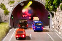 Radio-Mitteilungen über Stau geben Einblick in die motorisierte Volksseele. Modellautos stehen vor einem Tunnel.