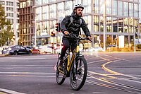 E-Bike-Boom hält weiterhin an. Ein Mann mit wetterfester Bekleidung fährt mit einem Elektrovelo in der Stadt Basel.